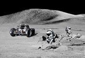 Image from the Apollo missions showing the lunar rover with astronauts investigating the moon surface. Click here to seem more lunar images.
